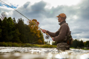 Man fly fishing in fall