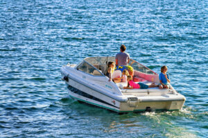 family on boat in lake