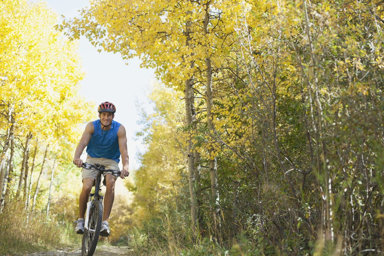 Guy on bike riding trails