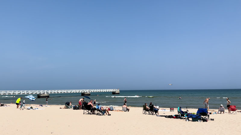 People relaxing at there waters edge at Oscoda Beach Park