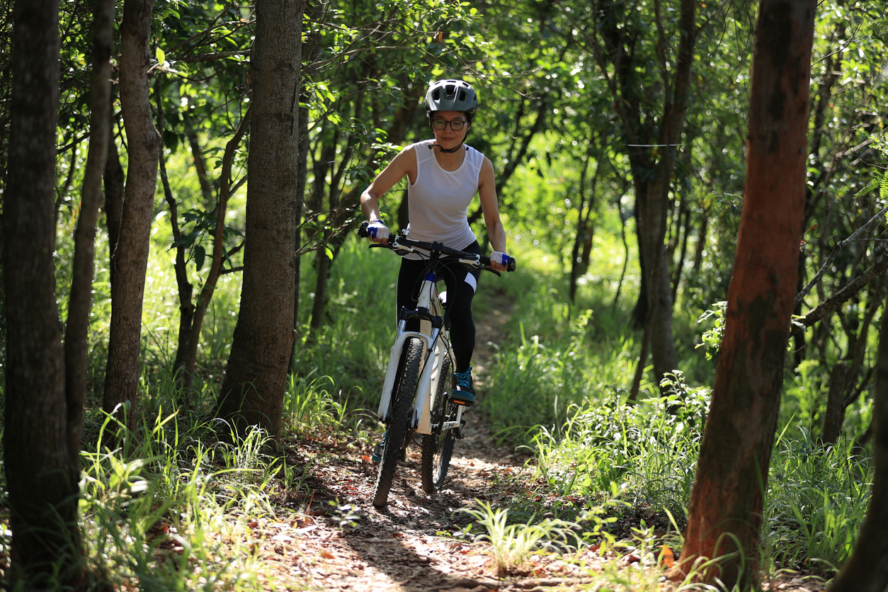 Woman on mountain bike riding trail