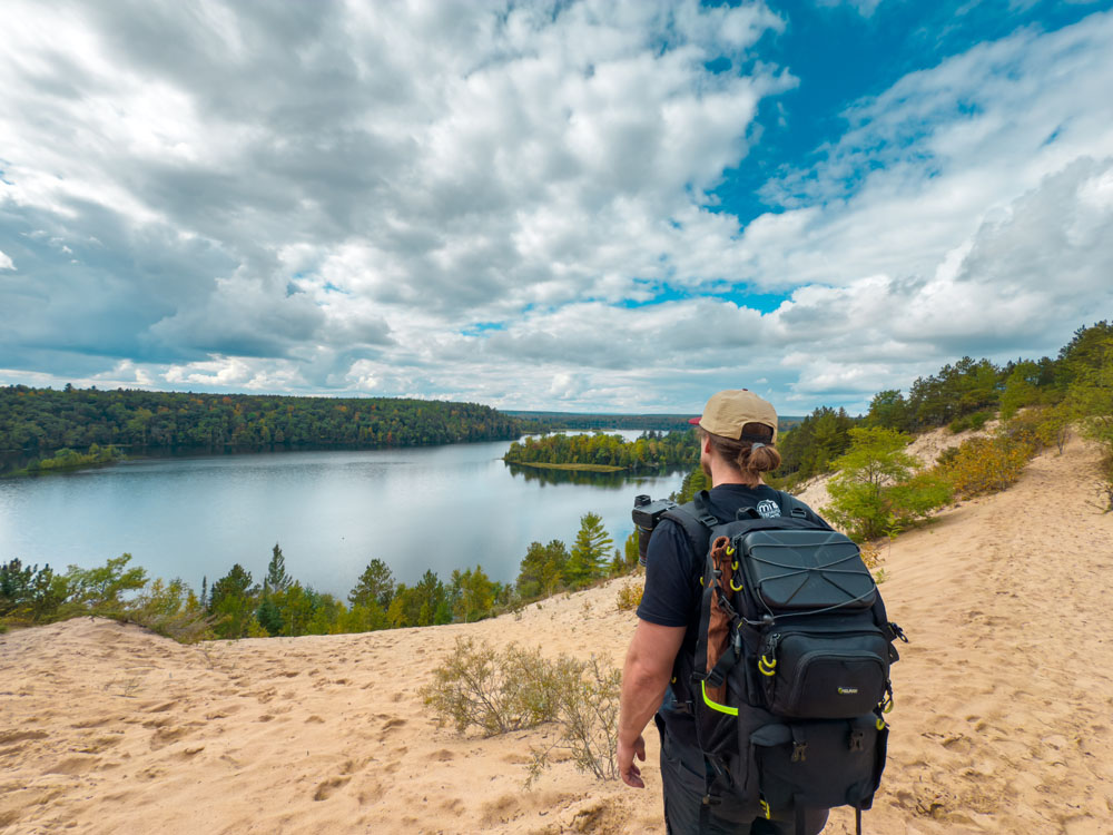 Hiker taking in view at overlook on Highbanks trail